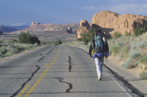 Man walking on highway alone. 